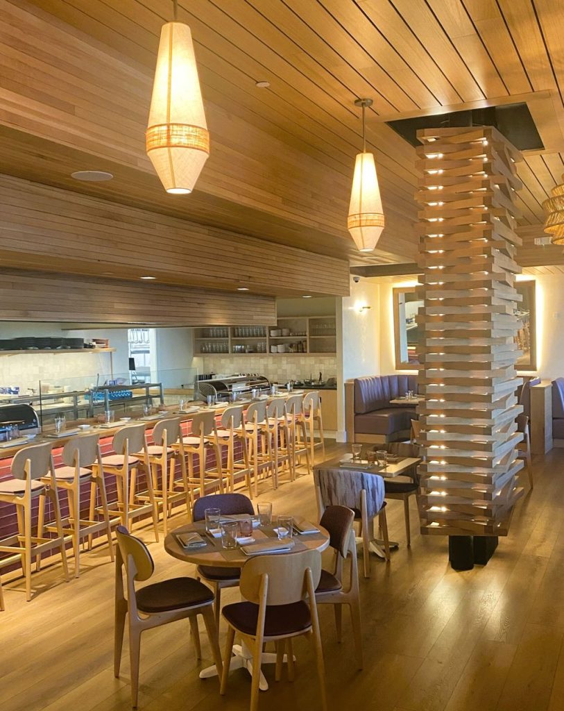 Restaurant interior featuring custom wood acoustic ceiling and wall treatments by Performance Acoustics.